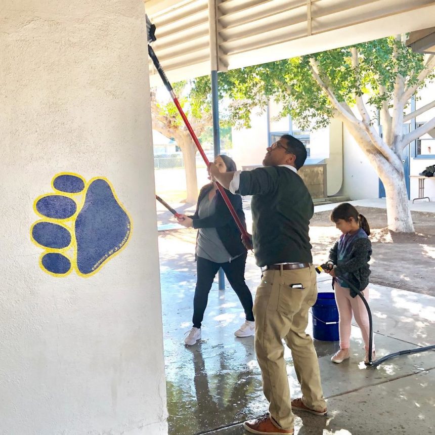 Community members cleaning school